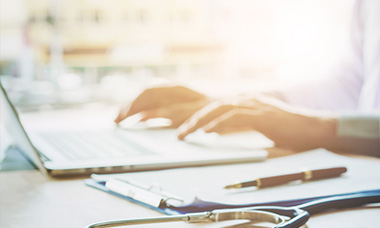 health professional using laptop